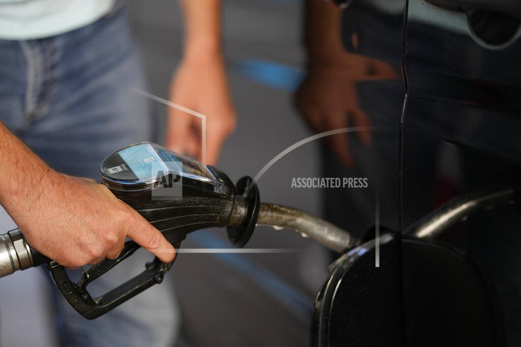 Alastair Grant A man puts diesel fuel into his car as he stops at a garage, in south London, Monday, Sept. 27, 2021. Lines of cars formed at British gas stations for a fourth day on Monday, as the government mulled sending in the army to help ease the supply disruptions, triggered by a shortage of truck drivers. (AP Photo/Alastair Grant)