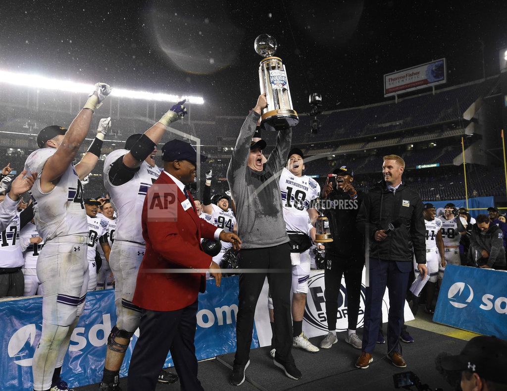 Denis Poroy Northwestern head coach Pat Fitzgerald, center, lifts the Holiday Bowl trophy after defeating Utah in the Holiday Bowl NCAA college football game Monday, Dec. 31, 2018, in San Diego. (AP Photo/Denis Poroy)