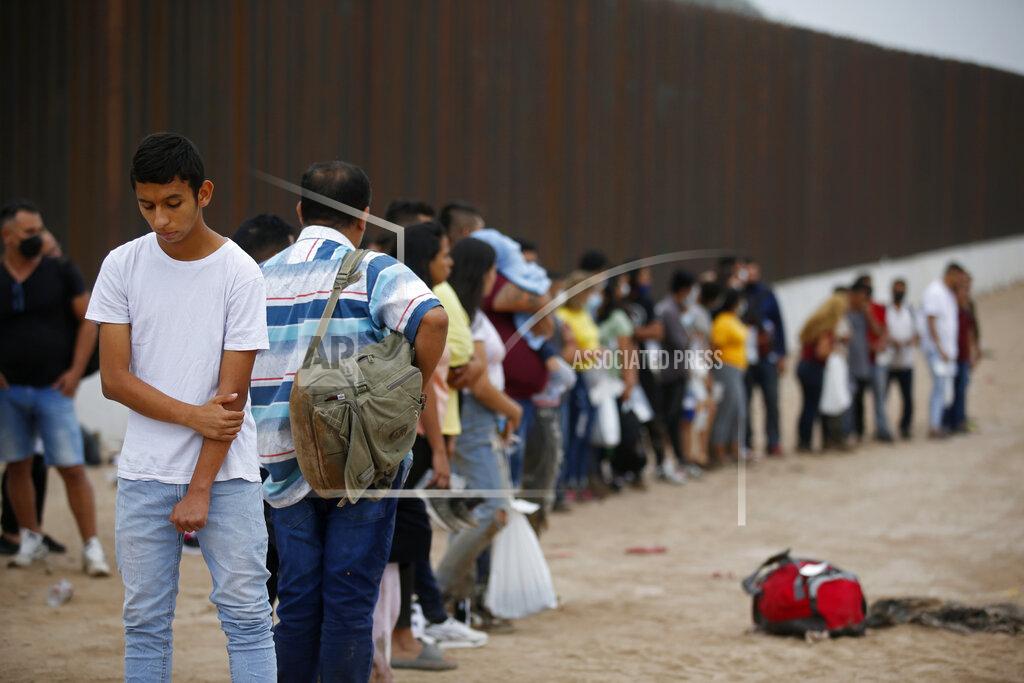 Dario Lopez-Mills Migrants who had crossed the Rio Grande river into the U.S. wait to be processed by U.S. Border Patrol agents in Eagle Pass, Texas, Friday, May 20, 2022. The Eagle Pass area has become increasingly a popular crossing corridor for migrants, especially those from outside Mexico and Central America, under Title 42 authority, which expels migrants without a chance to seek asylum on grounds of preventing the spread of COVID-19. A judge was expected to rule on a bid by Louisiana and 23 other states to keep Title 42 in effect before the Biden administration was to end it Monday. (AP Photo/Dario Lopez-Mills)