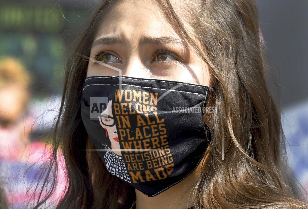 Keith Birmingham Hundreds protest on many issues including the Trump Administration's efforts to replace the late Supreme Court Justice Ruth Bader Ginsburg and asking people to get out and vote during the Los Angeles Women's March from Pershing Square to City Hall in Los Angeles on Saturday, Oct. 17, 2020. (Keith Birmingham/The Orange County Register via AP)