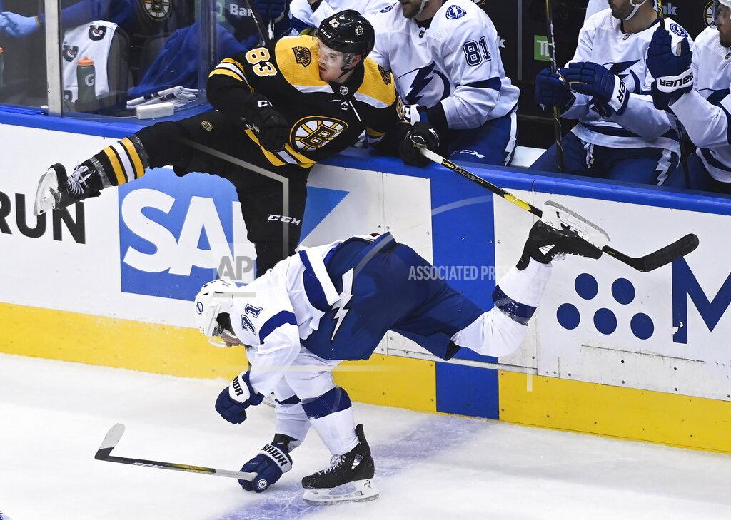 Nathan Denette Boston Bruins center Karson Kuhlman (83) hits Tampa Bay Lightning center Anthony Cirelli (71) during the third period of an NHL hockey playoff game Wednesday, Aug. 5, 2020 in Toronto. (Nathan Denette/The Canadian Press via AP)