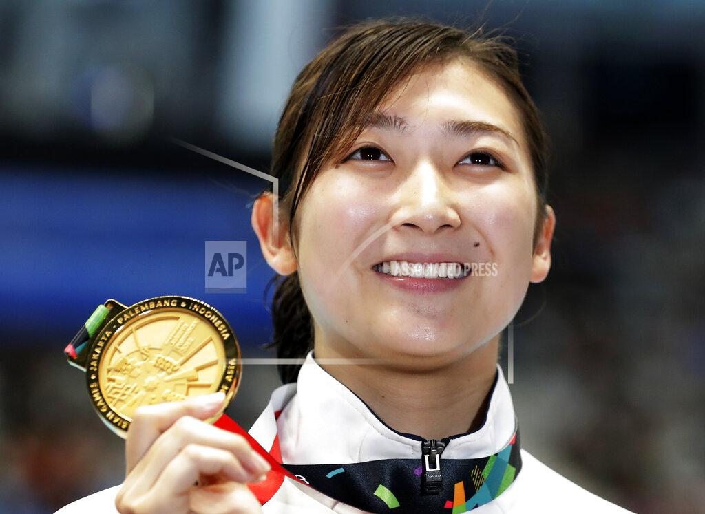 Lee Jin-Man FILE - In this Aug. 24, 2018, file photo, Japan's Rikako Ikee holds up her gold medal after winning the women's 50m freestyle final during the swimming competition at the 18th Asian Games in Jakarta, Indonesia. Ikee was the star of the Asian Games two years ago, winning six gold medals in Jakarta in freestyle and butterfly and was billed as Japan's Olympics star in 2020. However, she was diagnosed with leukemia early in 2019 and has undergone a year of difficult treatment. The 20-year-old says she hopes to compete in the 2024 Paris Olympics.(AP Photo/Lee Jin-man, File)