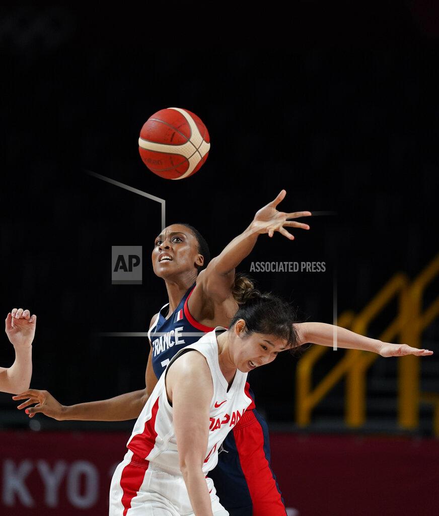 Charlie Neibergall France's Sandrine Gruda (7), left, and Japan's Moeko Nagaoka (0) fight to grab the rebound during women's basketball preliminary round game at the 2020 Summer Olympics, Tuesday, July 27, 2021, in Saitama, Japan. (AP Photo/Charlie Neibergall)
