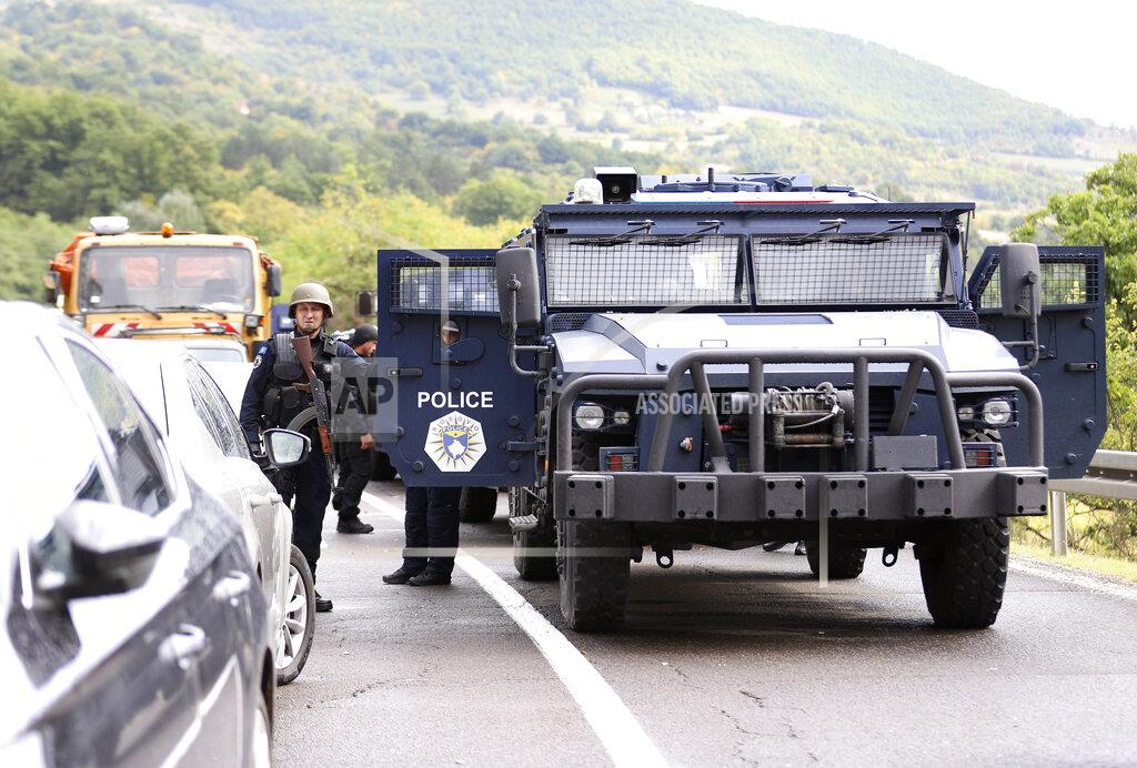 Bojan Slavkovic Kosovo special police with armored vehicles stand on the road near the northern Kosovo border crossing of Jarinje, Monday, Sept. 20, 2021. Tensions have soared on the border between Kosovo and Serbia as Pristina authorities started implementing a rule to remove Serbian license plates from cars entering Kosovo. Kosovo special police with armored vehicles were deployed Monday on the tense border as hundreds of Kosovo Serbs reportedly drove there in their cars to protest the move. (AP Photo/Bojan Slavkovic)