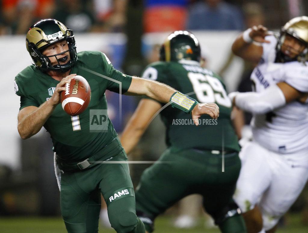 David Zalubowski FILE--In this Friday, Aug. 31, 2018, file photograph, Colorado State quarterback K.J. Carta-Samuels rolls out to pass under pressure during the second half of an NCAA college football game against Colorado in Denver. Colorado won 45-13. Carta-Samuels and the Rams will host Arkansas on Saturday. (AP Photo/David Zalubowski, File)