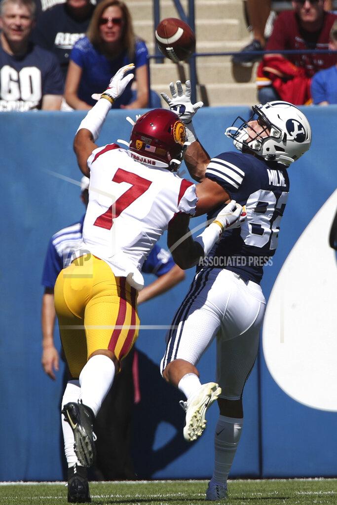 George Frey BYU wide receiver Dax Milne (82) catches a touchdown pass over Southern California cornerback Chase Williams (7) in the first half of an NCAA college football game, Saturday, Sept. 14, 2019, in Provo, Utah. (AP Photo/George Frey)