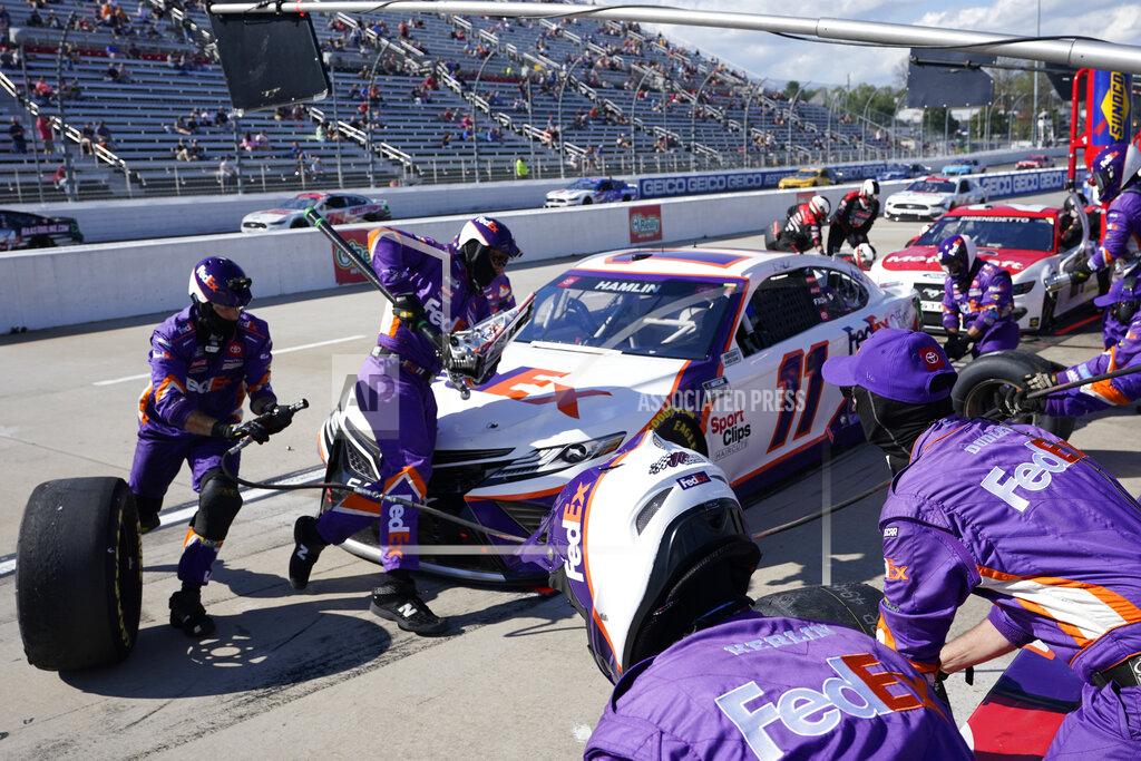 Steve Helber Denny Hamlin (11) gets service in the pits during the NASCAR Cup Series auto race at Martinsville Speedway in Martinsville, Va., Sunday, April 11, 2021. (AP Photo/Steve Helber)