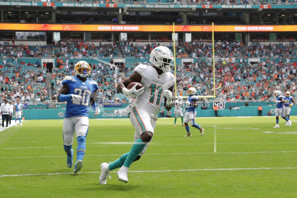 Lynne Sladky Miami Dolphins wide receiver DeVante Parker (11) runs for a touchdown ahead of Los Angeles Chargers defensive back Desmond King (20), during the first half at an NFL football game, Sunday, Sept. 29, 2019, in Miami Gardens, Fla. AP Photo/Lynne Sladky)