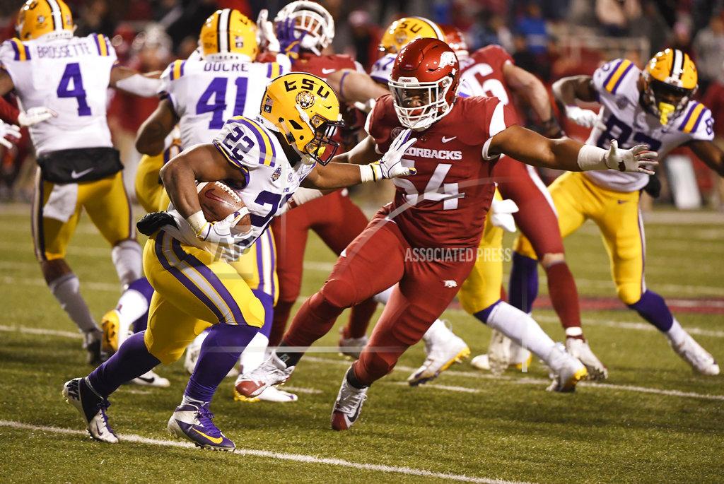 Michael Woods LSU running back Clyde Edwards-Helaire runs past Arkansas defender Terrell Collins during the second half of an NCAA college football game, Saturday, Nov. 10, 2018, in Fayetteville, Ark. LSU won, 24-17. (AP Photo/Michael Woods)