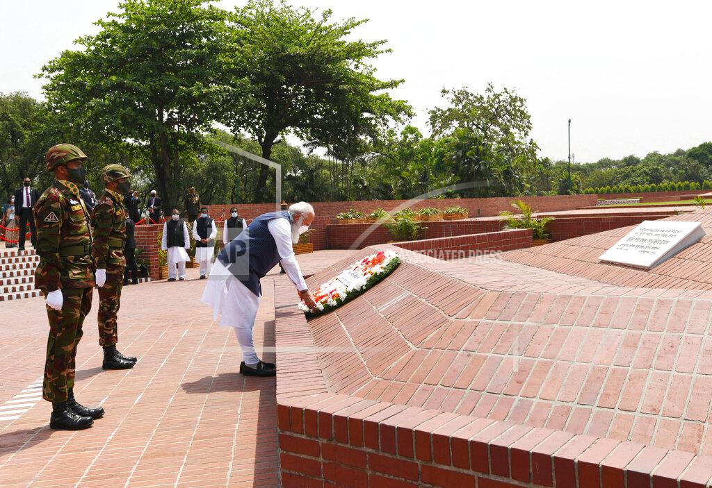 Uncredited In this photo provided by Prime Minister of India Narendra Modi's twitter handle, Indian Prime Minister Narendra Modi places a floral wreath at the National Martyrs' Memorial in Dhaka, Bangladesh, Friday, March 26, 2021. Modi arrived in Bangladesh’s capital on Friday to join celebrations marking 50 years of the country's independence, but his trip was not welcomed by all. The two-day visit, his first foreign trip since the coronavirus pandemic began last year, will also include joining commemorations for 100 years since the birth of independence leader Sheikh Mujibur Rahman, the father of current Prime Minister Sheikh Hasina. (Prime Minister of India Narendra Modi's twitter handle via AP Photo)