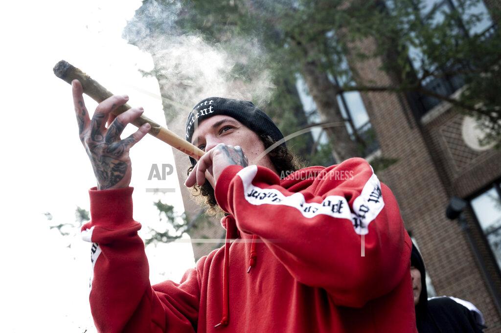Jacob Hamilton Dave McGinley smokes a joint at a Hash Bash event at the University of Michigan in Ann Arbor, Mich., Saturday, April 3, 2021.( Jacob Hamilton/Ann Arbor News via AP)