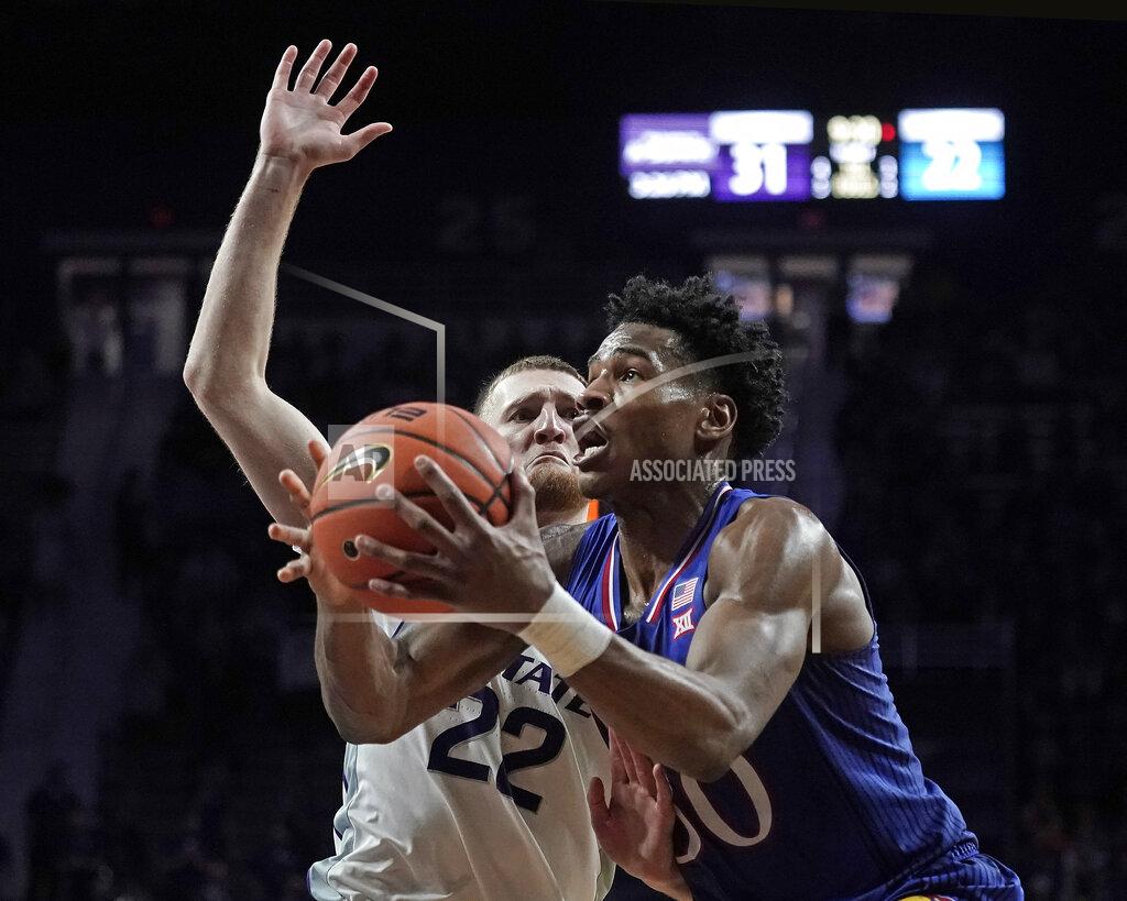 Charlie Riedel Kansas guard Ochai Agbaji (30) gets past Kansas State guard Luke Kasubke (22) to shoot during the first half of an NCAA college basketball game Saturday, Jan. 22, 2022, in Manhattan, Kan. (AP Photo/Charlie Riedel)