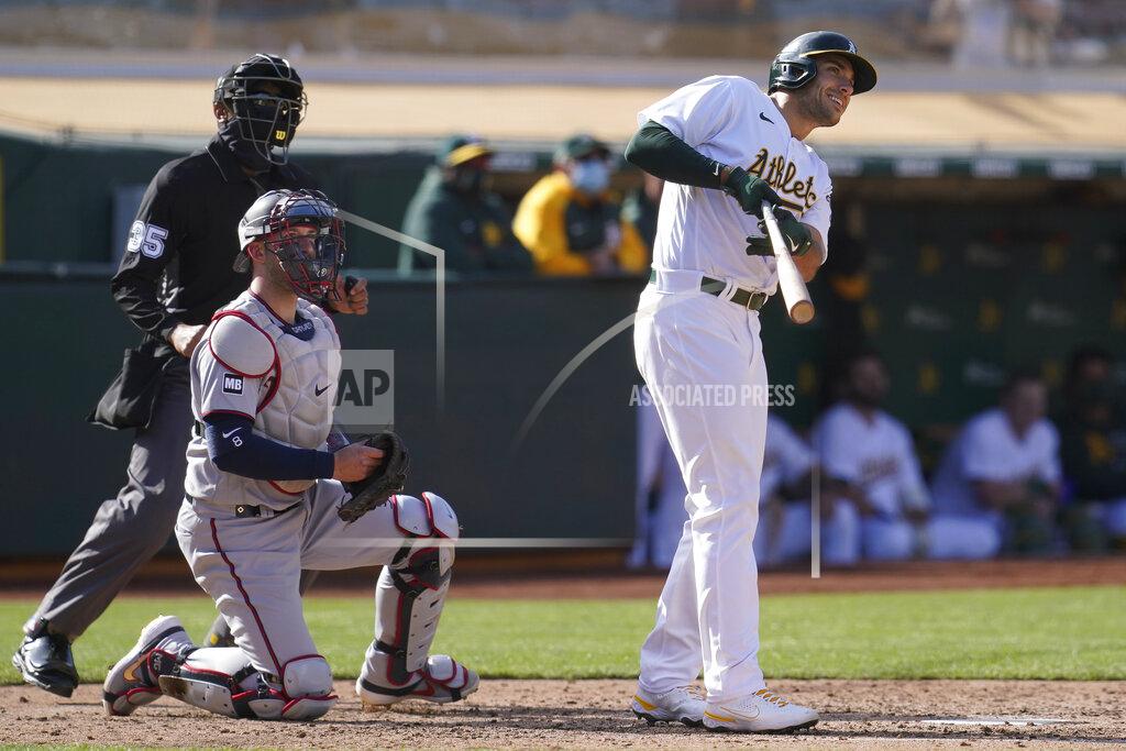 Jeff Chiu Oakland Athletics' Matt Olson, right, watches his grand slam home run in front of Minnesota Twins catcher Mitch Garver during the fourth inning of the first baseball game of a doubleheader in Oakland, Calif., Tuesday, April 20, 2021. (AP Photo/Jeff Chiu)