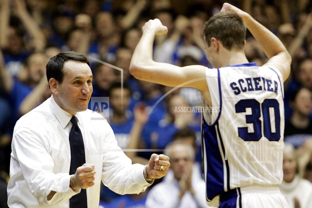 FILE- In this Feb. 22, 2009, file photo, Duke coach Mike Krzyzewski congratulates Jon Scheyer (30) late in the second half of an NCAA college basketball game against Wake Forest in Durham, N.C. Duke Hall of Fame coach Mike Krzyzewski will coach his final season with the Blue Devils in 2021-22, a person familiar with the situation said Wednesday, June 2, 2021. The person said former Duke player and associate head coach Jon Scheyer would then take over as Krzyzewski's successor for the 2022-23 season. (AP Photo/Gerry Broome, File)