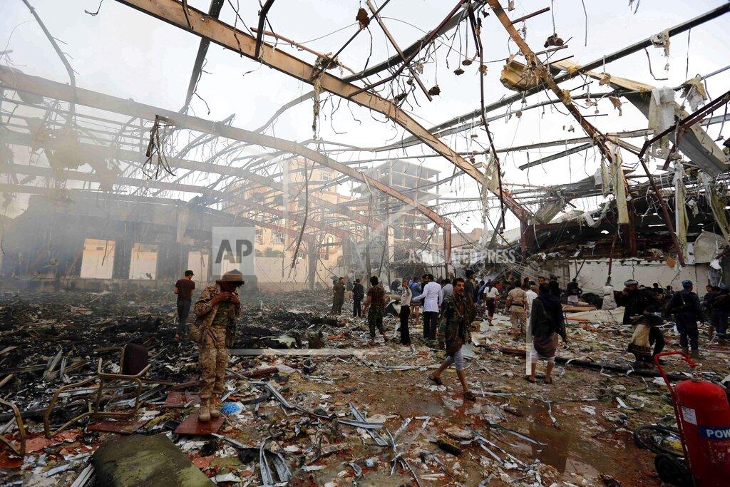 Osamah Abdulrhman FILE - In this Oct. 8, 2016 file photo, people inspect the aftermath of a Saudi-led coalition airstrike in Sanaa, Yemen. Yemen’s war began in September 2014, when the Houthis seized the capital Sanaa. Saudi Arabia, along with the United Arab Emirates and other countries, entered the war alongside Yemen’s internationally recognized government in March 2015. The war has killed some 130,000 people and driven the Arab world’s poorest country to the brink of famine. (AP Photo/Osamah Abdulrhman, File)