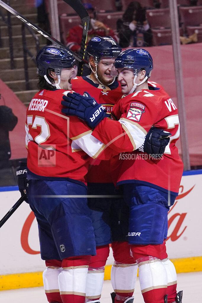 Marta Lavandier Florida Panthers defenseman MacKenzie Weegar (52) congratulates center Frank Vatrano, right, after Vatrano scored in overtime of the team's NHL hockey game against the Chicago Blackhawks, Tuesday, Jan. 19, 2021, in Sunrise. The Panthers won 5-4. (AP Photo/Marta Lavandier)