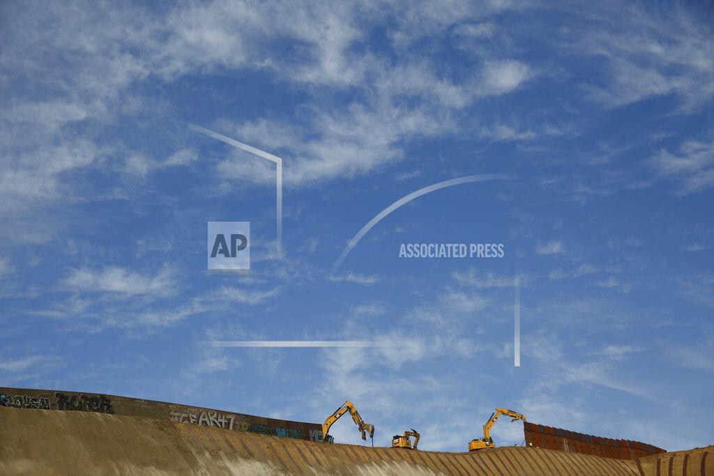 Gregory Bull FILE- Workers replace sections of the border wall separating San Diego from Tijuana, Mexico, left, with new sections, right, Tuesday, Jan. 8, 2019, seen from Tijuana. Top Trump administration officials will visit South Texas five days before Election Day to announce they have completed 400 miles of U.S.-Mexico border wall, attempting to show progress on perhaps the president's best-known campaign promise four years ago. But most of the wall went up in areas that already had smaller barriers. (AP Photo/Gregory Bull)