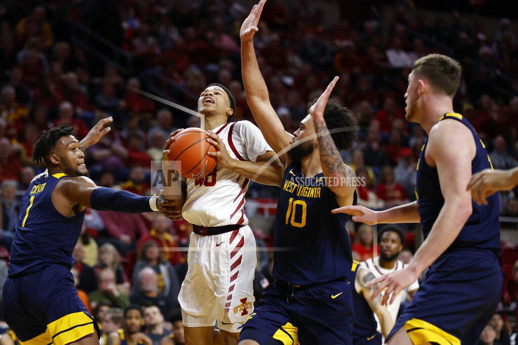 Matthew Putney Iowa State guard Rasir Bolton, center, drives the ball inside as West Virginia forward Derek Culver, left, and guard Jermaine Haley, right, defend during the first half of an NCAA college basketball game Tuesday, March 3, 2020, in Ames, Iowa. (AP Photo/Matthew Putney)