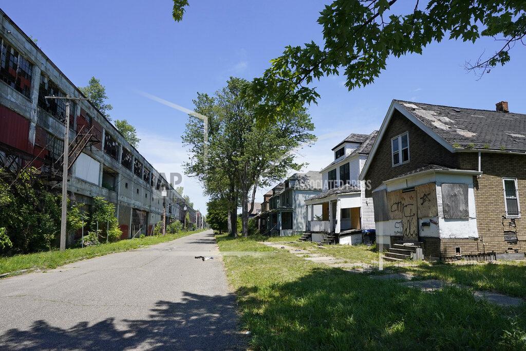 Carlos Osorio Exterior of the Packard Plant, left, next to boarded up houses on Detroit's east side, Thursday, June 30, 2022. The factory built in the early 1900s turned out high-end cars into the 1950s. It was considered one of the city's automotive jewels, but now is among the nation's most notorious examples of urban blight. Parts of the 3.5 million-square-foot, 40-acre Packard plant complex will be demolished by the year's end. (AP Photo/Carlos Osorio)