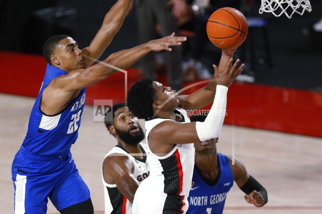 Joshua L. Jones Georgia's Sahvir Wheeler (2) shoots while being defended by North Georgia forward Eric Jones (22) during an NCAA college basketball exhibition game in Athens, Ga., Wednesday, Dec. 2, 2020. (Joshua L. Jones/Athens Banner-Herald via AP)