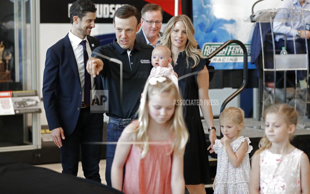 Chuck Burton FILE - In this April 25, 2018, file photo, NASCAR driver Matt Kenseth gestures towards a race car as he walks with his family before unveiling the car during a news conference in Charlotte, N.C. Kenseth had the best summer of his life last year, when he traveled with his wife and four daughters, made his first visit to Europe and took up marathon running. It was a blissful retirement, yet he gave it up this week when he agreed to return to NASCAR as the replacement for fired driver Kyle Larson. At 48, he will be the oldest driver in the field when racing resumes. (AP Photo/Chuck Burton, File)