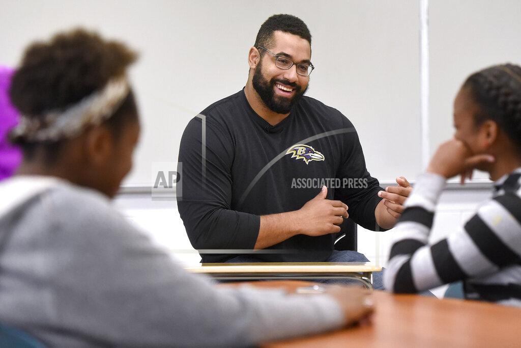 Steve Ruark FILE - Baltimore Ravens lineman and math scholar John Urschel teaches a lesson at Dundalk High School to launch Texas Instruments' STEM Behind Cool Careers series in Baltimore, in this Tuesday, July 18, 2017, file photo. John Urschel has found that a master's degree in mathematics, his stature as an accomplished author and his pending PhD at MIT isn't necessarily enough to sell young students on the benefit of crunching numbers.
What really makes him interesting to most kids is that he's a former NFL player who opted to immerse himself in math. (Steve Ruark/AP Images for Texas Instruments, File)