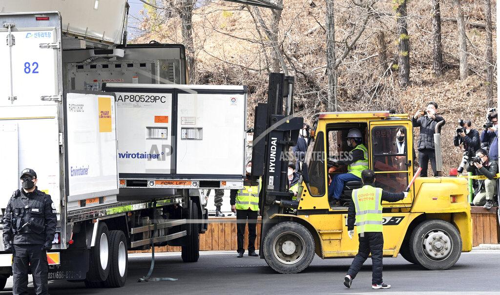 Uncredited A container containing AstraZeneca's coronavirus vaccines is unloaded from a truck at a distribution center in Icheon, South Korea, Wednesday, Feb. 24, 2021. South Korea's top infectious disease expert has warned that vaccines will not end the coronavirus pandemic quickly as the country prepared to give its first vaccinations this week. (Yonhap via AP)