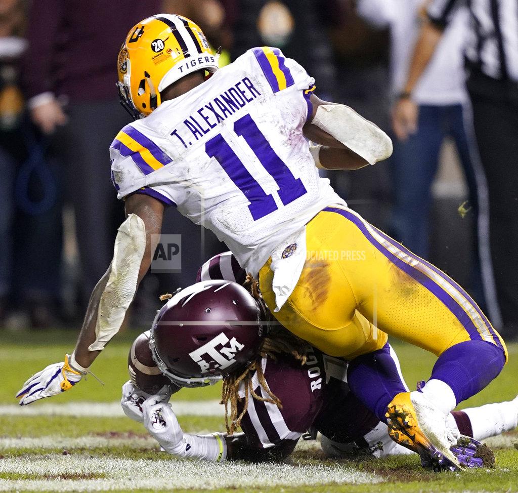 David J. Phillip Texas A&M wide receiver Kendrick Rogers, bottom, catches a pass in the end zone for a touchdown as LSU cornerback Terrence Alexander (11) defends during overtime of an NCAA college football game Saturday, Nov. 24, 2018, in College Station, Texas. Texas A&M won 74-72 in seven overtimes. (AP Photo/David J. Phillip)