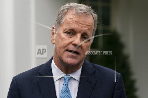 FILE - Doug Parker, CEO of American Airlines, speaks with reporters after a meeting with White House Chief of Staff Mark Meadows at the White House, Thursday, Sept. 17, 2020, in Washington. American Airlines CEO Doug Parker will retire next March and be replaced by the airline's current president, Robert Isom. American said Tuesday, Dec. 7, 2021, that Parker will remain chairman. (AP Photo/Alex Brandon, File)
