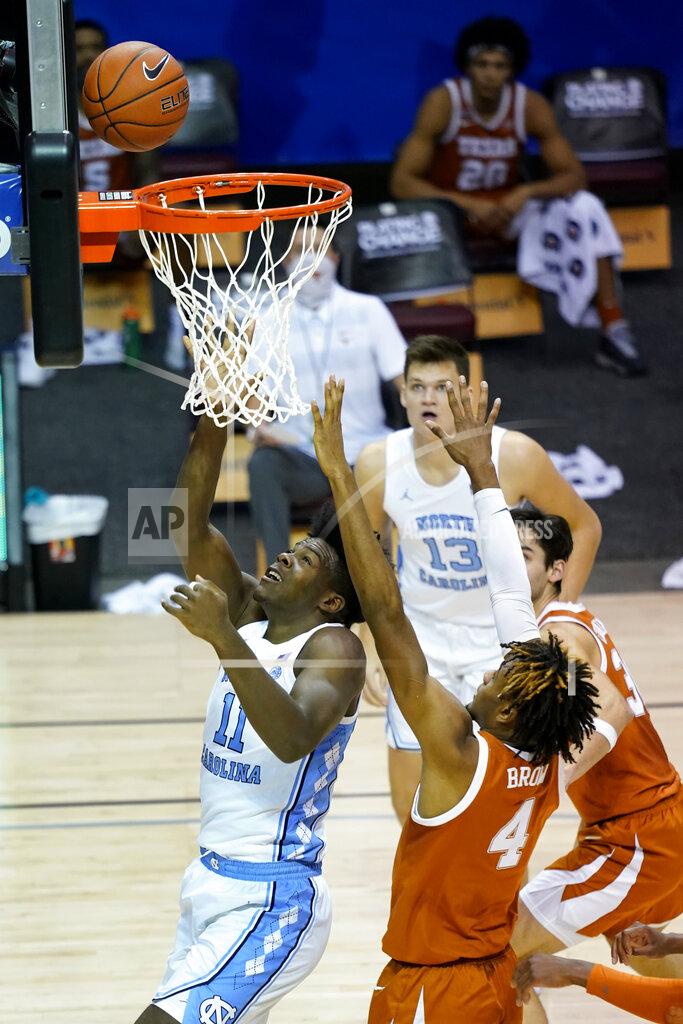 Kathy Kmonicek North Carolina forward Day'Ron Sharpe (11) shoots a basket past Texas forward Greg Brown (4) in the first half of an NCAA college basketball game for the championship of the Maui Invitational, Wednesday, Dec. 2, 2020, in Asheville, N.C. (AP Photo/Kathy Kmonicek)