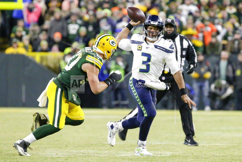 Mike Roemer Seattle Seahawks' Russell Wilson scrambles during the first half of an NFL divisional playoff football game against the Green Bay Packers Sunday, Jan. 12, 2020, in Green Bay, Wis. (AP Photo/Mike Roemer)