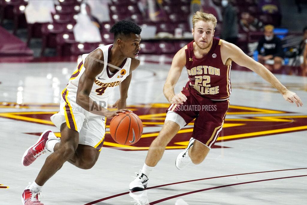 Jim Mone Minnesota's Jamal Washburn Jr. (4) drives on Boston College's Rich Kelly during the first half of an NCAA college basketball game Tuesday, Dec. 8, 2020, in Minneapolis. (AP Photo/Jim Mone)