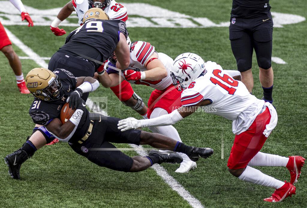 Daniel Lin James Madison running back Percy Agyei-Obese (31) dives for yardage as he evades Richmond defensive back Aamir Hall (16) during the first half of an NCAA college football game in Harrisonburg, Va., Saturday, April 17, 2021. (Daniel Lin/Daily News-Record Via AP)