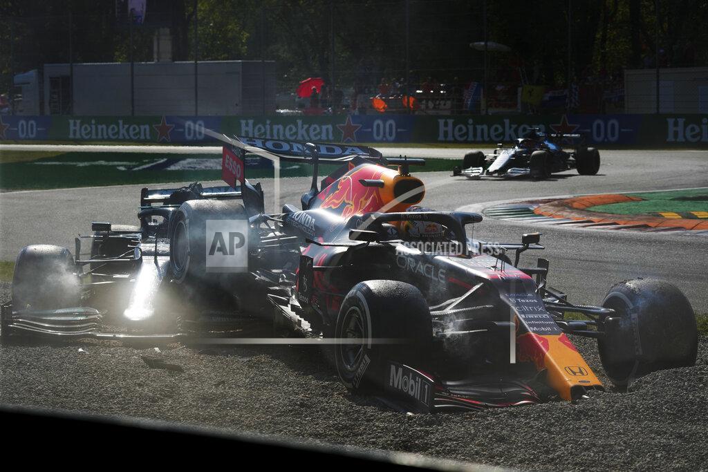 Luca Bruno Red Bull driver Max Verstappen of the Netherlands, right and Mercedes driver Lewis Hamilton of Britain crash during the Italian Formula One Grand Prix, at Monza racetrack, in Monza, Italy, Sunday, Sept.12, 2021. (AP Photo/Luca Bruno)