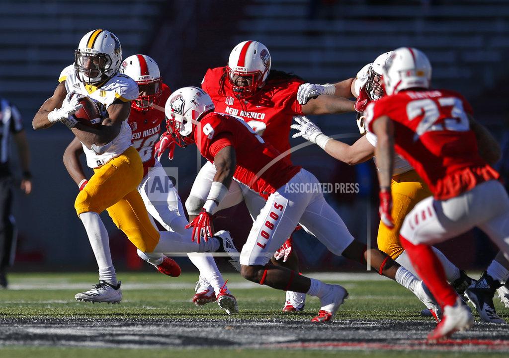Andres Leighton Wyoming running back Xazavian Valladay, far left, breaks away from the New Mexico defense during the second half of an NCAA college football game in Albuquerque, N.M., Saturday, Nov. 24, 2018. Wyoming won 31-3. (AP Photo/Andres Leighton)
