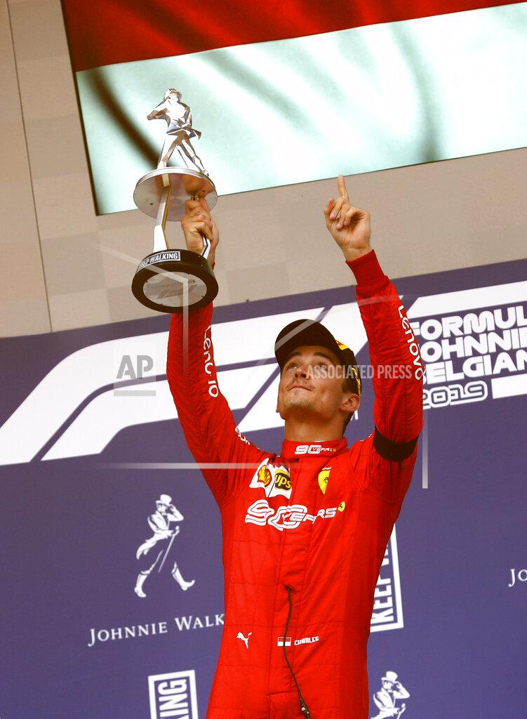 Ferrari driver Charles Leclerc of Monaco lifts the trophy after finishing first in the Belgian Formula One Grand Prix in Spa-Francorchamps, Belgium, Sunday, Sept. 1, 2019. Mercedes driver Lewis Hamilton of Britain placed second and Mercedes driver Valtteri Bottas of Finland placed third. (AP Photo/Francisco Seco)