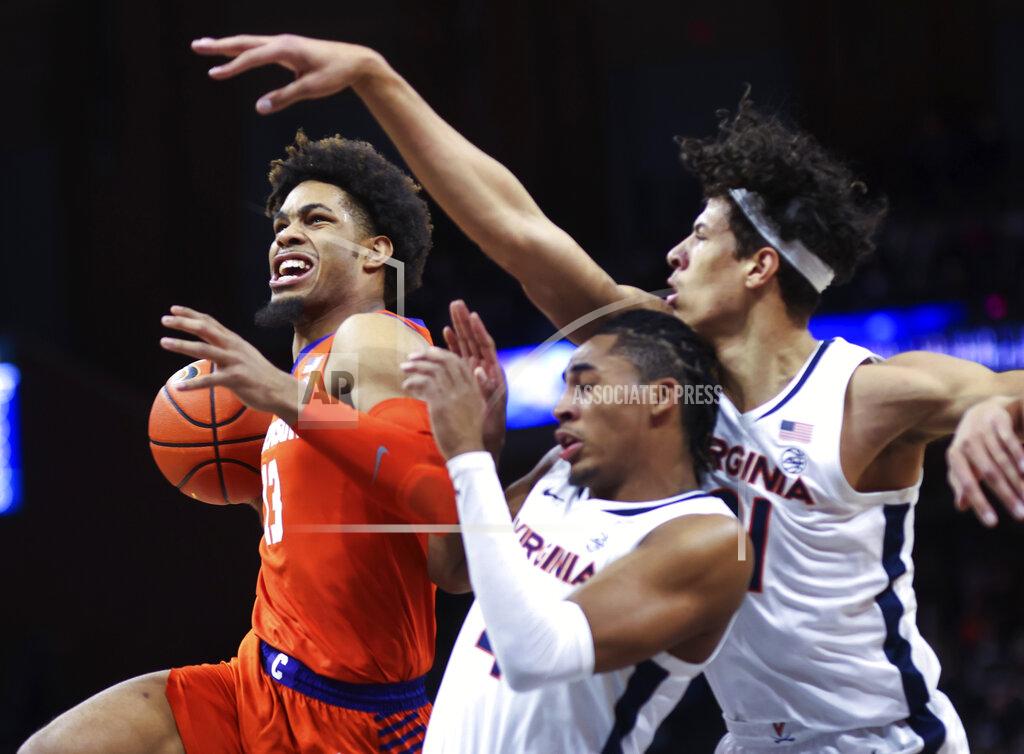 Andrew Shurtleff Clemson guard David Collins (13) moves past Virginia guard Armaan Franklin (4) and forward Kadin Shedrick (21) during an NCAA college basketball game in Charlottesville, Va., Wednesday, Dec. 22, 2021. (AP Photo/Andrew Shurtleff)
