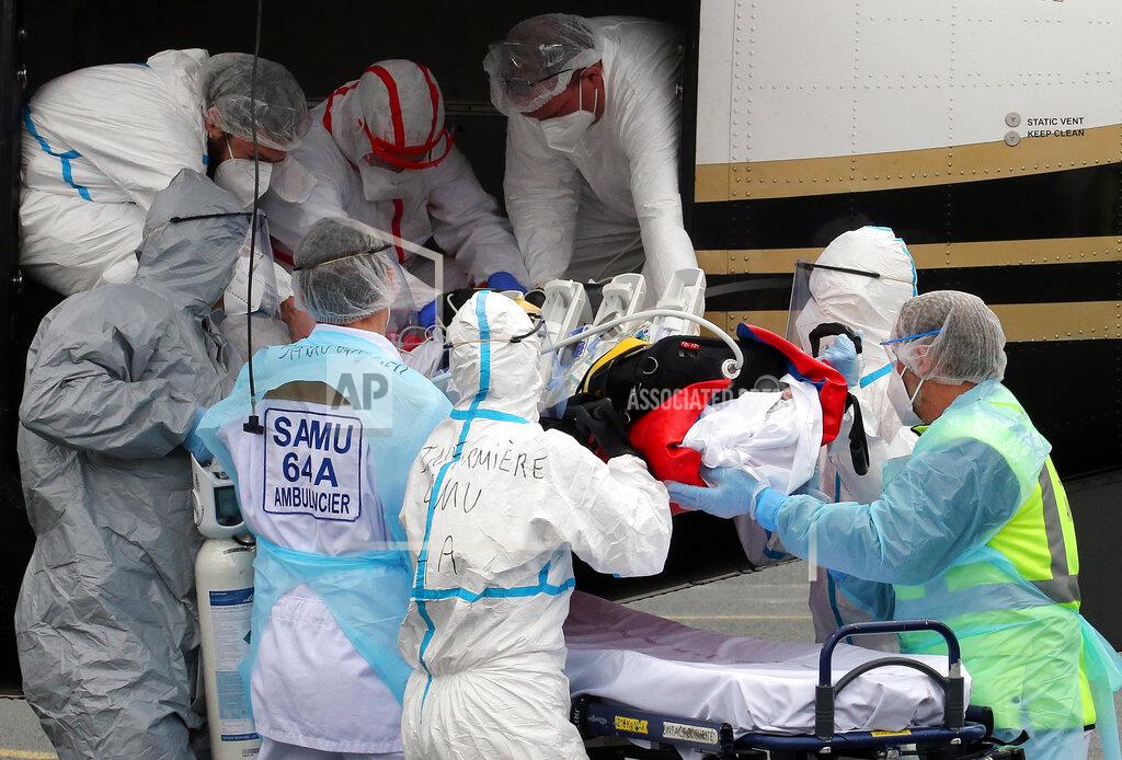 Bob Edme FILE- In this March 19, 2021, file photo, a patient from the Paris region and affected by the COVID-19 virus is taken out a plane at the Biarritz's airport, southwestern France. France's president say he has nothing to be sorry about for refusing to impose a third virus lockdown earlier this year, even though his country is now facing surging infections that are straining hospitals and more than 1,000 people with the virus are dying every week. (AP Photo/Bob Edme, File)