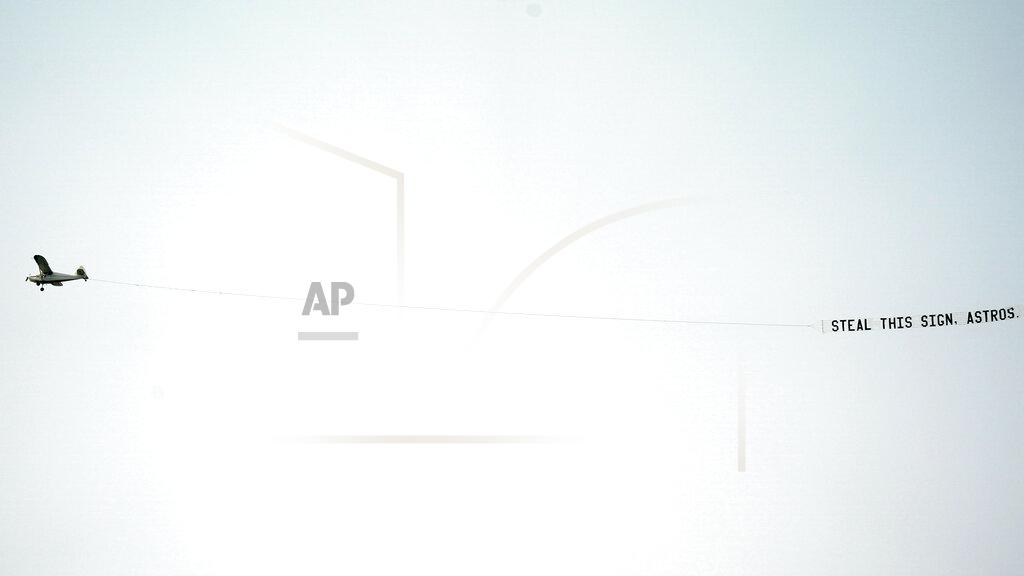Alex Gallardo A sign flies tethered to an airplane over Dodger Stadium as the Houston Astros warm up prior to a baseball game against the Los Angeles Dodgers in Los Angeles, Sunday, Sept. 13, 2020. (AP Photo/Alex Gallardo)