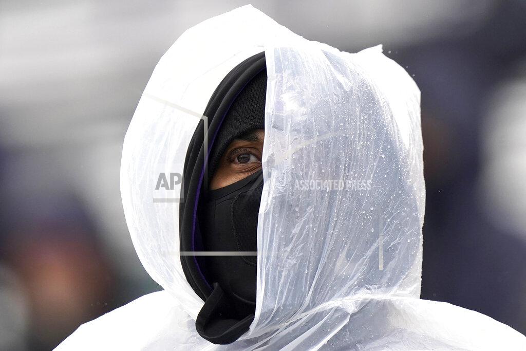 Nam Y. Huh A Northwestern fan covers up for the rain as he watches an NCAA college football game between Illinois and Northwestern during the second half in Evanston, Ill., Saturday, Dec. 12, 2020. Northwestern won 28-10. (AP Photo/Nam Y. Huh)