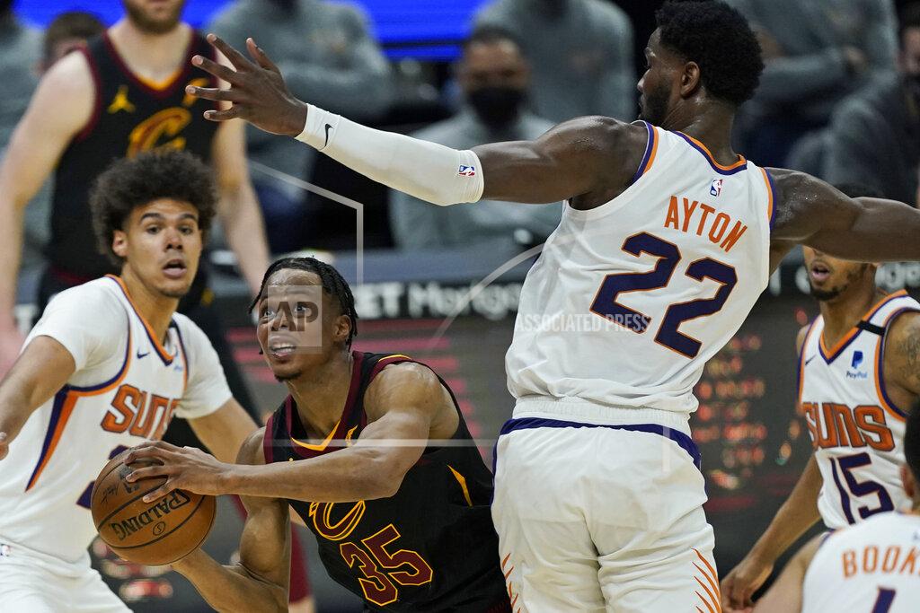 Tony Dejak Cleveland Cavaliers' Isaac Okoro (35) drives to the basket against Phoenix Suns' Deandre Ayton (22) in the second half of an NBA basketball game, Tuesday, May 4, 2021, in Cleveland. (AP Photo/Tony Dejak)