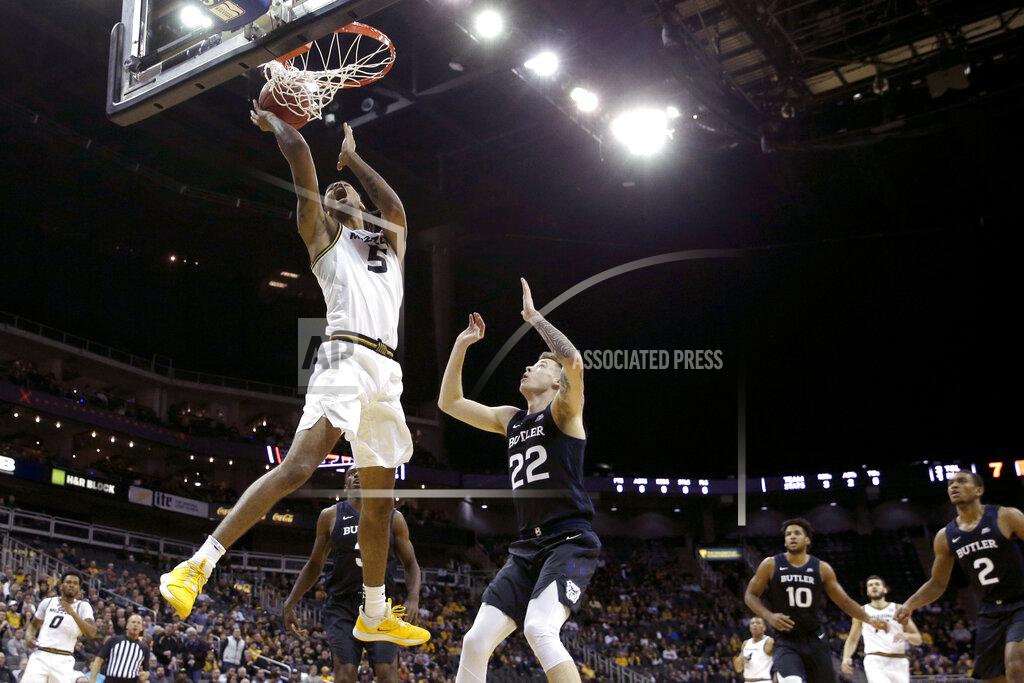 Charlie Riedel Missouri forward Mitchell Smith (5) shoots under pressure from -Butler forward Sean McDermott (22) during the first half of an NCAA college basketball game Monday, Nov. 25, 2019, in Kansas City, Mo. (AP Photo/Charlie Riedel)