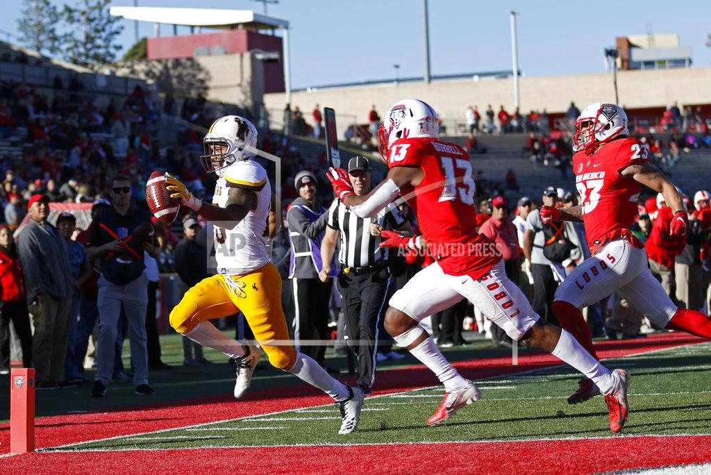 Andres Leighton Wyoming wide receiver Austin Conway, left, scores a touchdown ahead of New Mexico cornerback Jalin Burrell (13) and safety Marcus Hayes (23) during the second half of an NCAA college football game in Albuquerque, N.M., Saturday, Nov. 24, 2018. Wyoming won 31-3. (AP Photo/Andres Leighton)