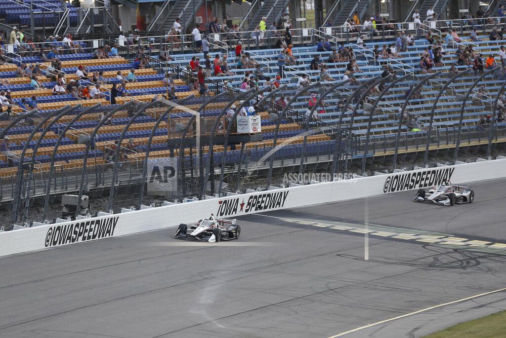 Josef Newgarden leads Will Power, of Australia, right, during the IndyCar Series auto race, Saturday, July 18, 2020, at Iowa Speedway in Newton, Iowa. (AP Photo/Charlie Neibergall)