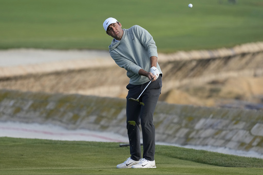 Scottie Scheffler chips to the 18th green at Pebble Beach Golf Links during the second round of the AT&amp;T Pebble Beach National Pro-Am golf tournament in Pebble Beach, Calif., Friday, Feb. 2, 2024. (AP Photo/Eric Risberg)