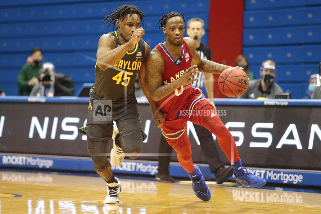 Evert Nelson Kansas guard Marcus Garrett, front right, avoids Baylor guard Davion Mitchell (45) in the second half of an NCAA college basketball game in Lawrence, Kan., Saturday, Feb. 27, 2021. (Evert Nelson/The Topeka Capital-Journal via AP)