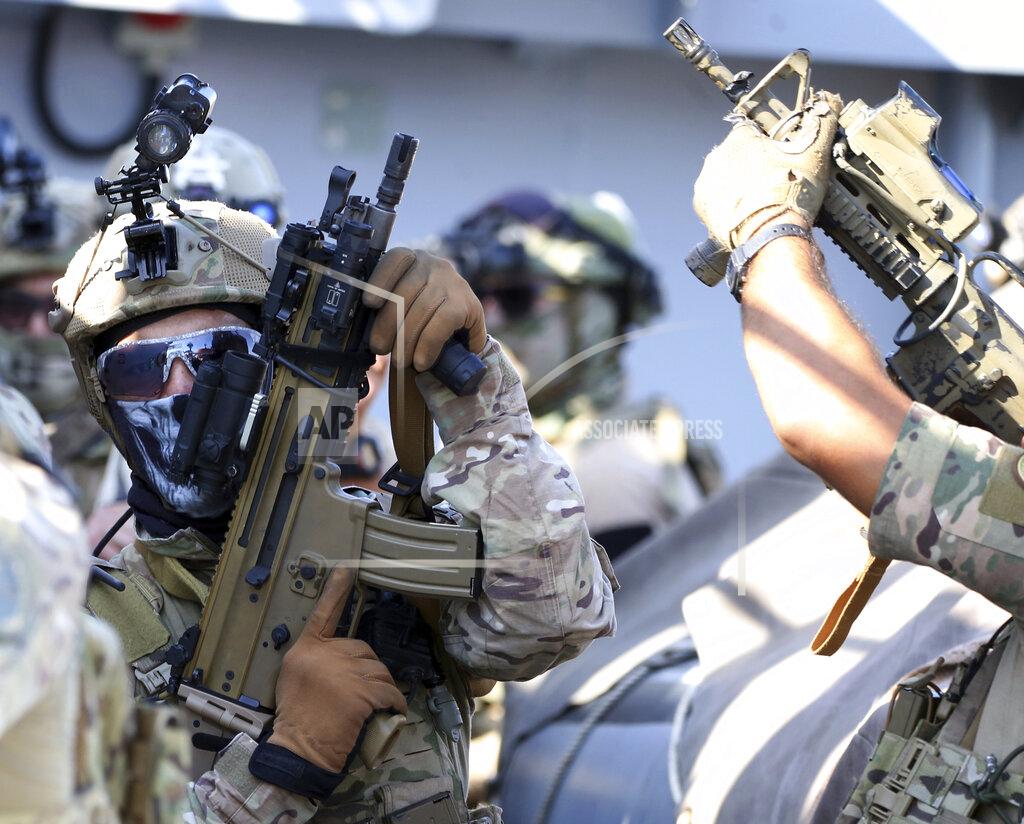 Philippos Christou Special forces operators hold their weapons during a joint U.S.-Cyprus military drill at Limassol port on Friday, Sept. 10, 2021. Cyprus' Defense Minister Charalambos Petrides said the U.S. and Cyprus are on the same strategic path to ensure security and stability in a turbulent region and that continued close cooperation between the special forces of both countries aim to counter threats from potential terrorist acts. (AP Photo/Philippos Christou)