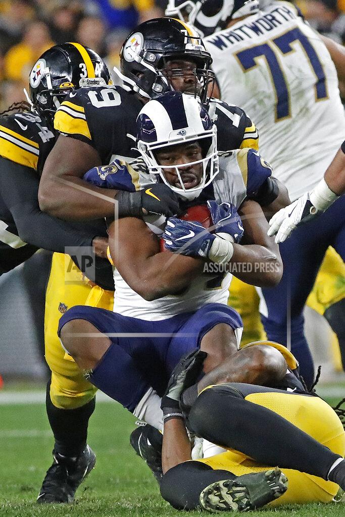 Don Wright Los Angeles Rams running back Malcolm Brown (34) is tackled by Pittsburgh Steelers nose tackle Javon Hargrave (79) and outside linebacker Bud Dupree, bottom right, during the second half of an NFL football game in Pittsburgh, Sunday, Nov. 10, 2019. (AP Photo/Don Wright)