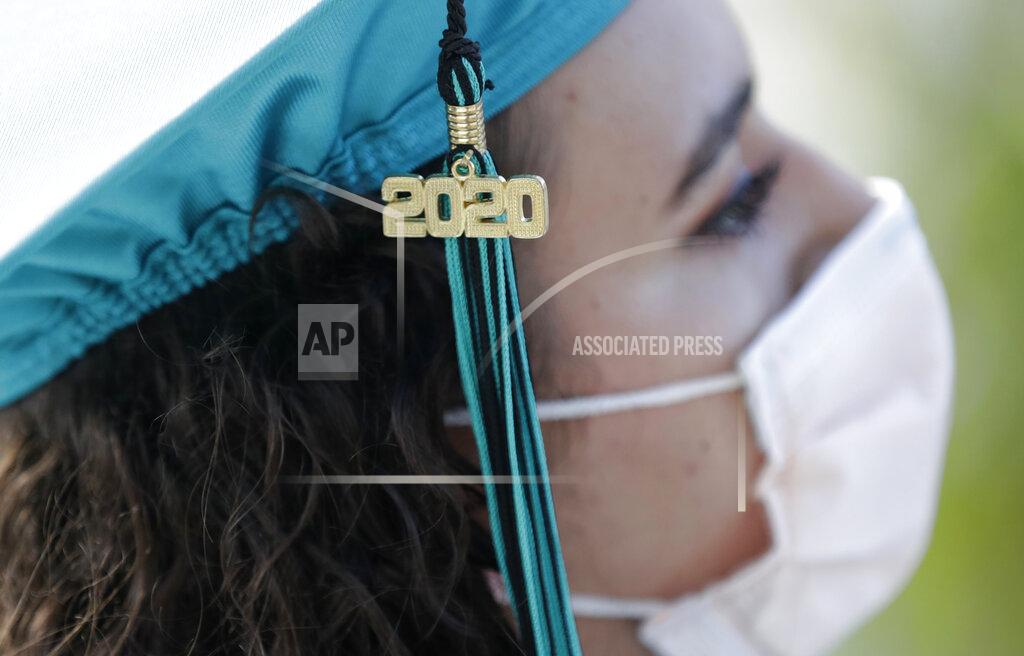Wilfredo Lee FILE - In this June 23, 2020, file photo, Valedictorian Sierra Morgado's graduation tassel has "2020" on it as she listens during a graduation ceremony for the senior class of Chambers High School at Homestead-Miami Speedway in Homestead, Fla. (AP Photo/Wilfredo Lee, File)