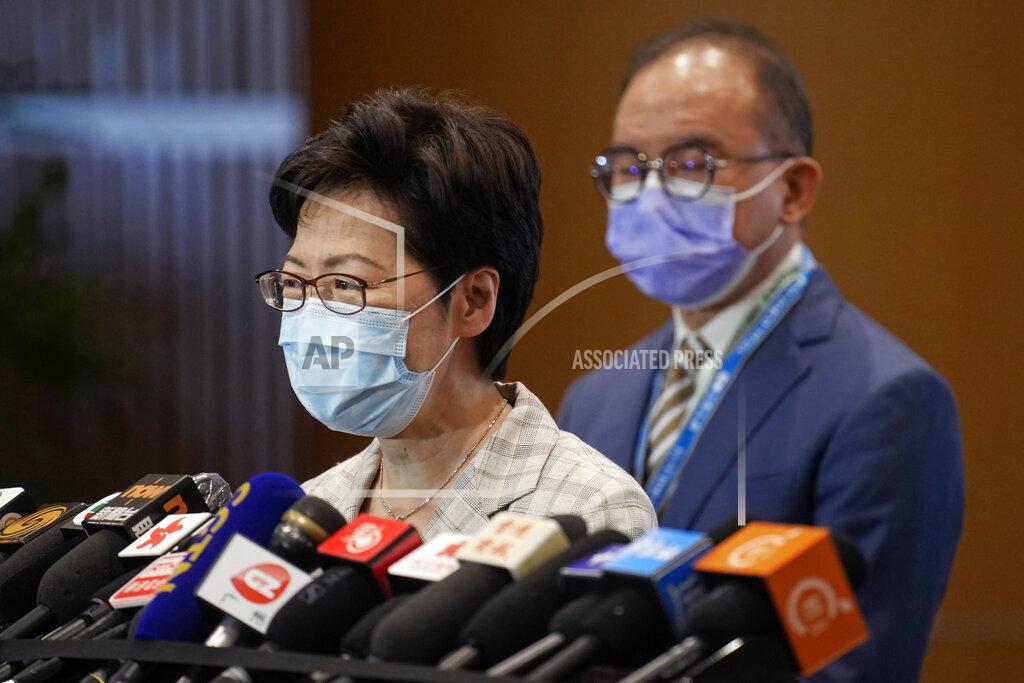 Vincent Yu Hong Kong Chief Executive Carrie Lam, left, speaks, with Erick Tsang, Secretary for Constitutional and Mainland Affairs Bureau, behind her, during a press conference at a polling center for the election committee in Hong Kong Sunday, Sept. 19, 2021. Hong Kong's polls for an election committee that will vote for the city's leader kicked off Sunday amid heavy police presence, with chief executive Carrie Lam saying that it is "very meaningful" as it is the first election to take place following electoral reforms. (AP Photo/Vincent Yu)